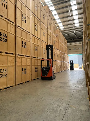 Secure storage and removal warehouse with packed furniture crates ready for delivery